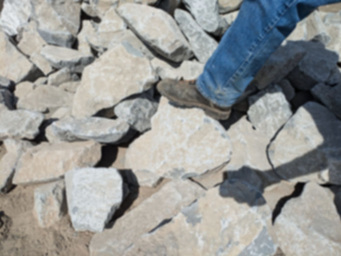 A boot standing on Columbia Granite - 1 - 2 man showing size and scale