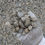 Thumbnail: grey gloved hand holding 1 1/4" minus aggregate ledge rock gravel