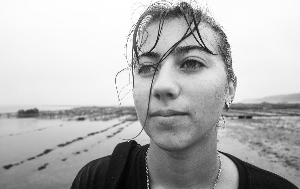 Documentary portrait of a young woman shellfisher.