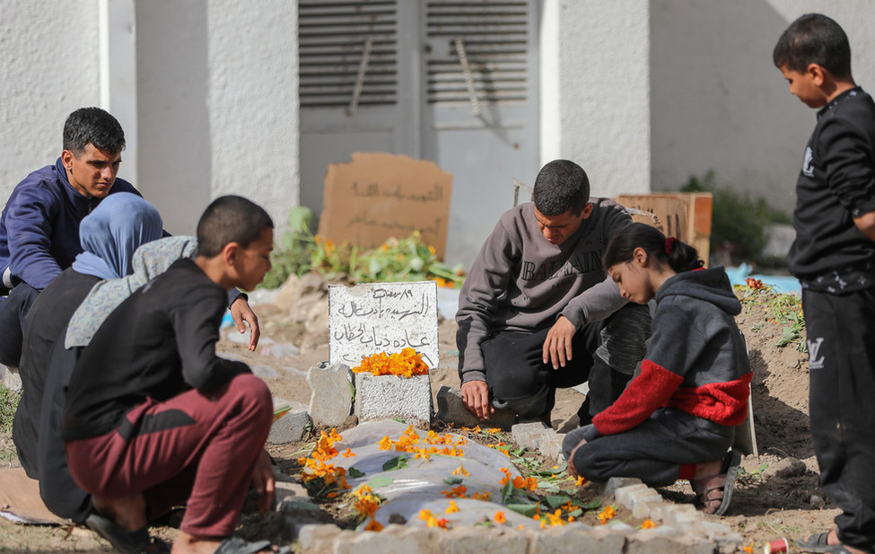 Palestinians gather after a family member was killed in an Israeli airstrike in Gaza.