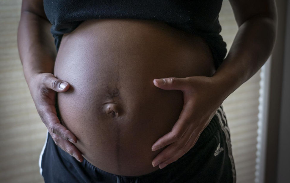 Documentary photograph of a Black mothers belly.