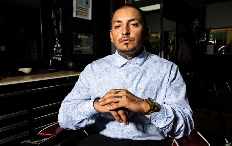 Documentary portrait of a man who works at ethnic hair care by Milo Gladstein.