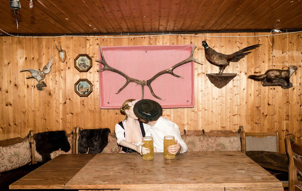 Portrait of a doll and its owner sharing a kiss.