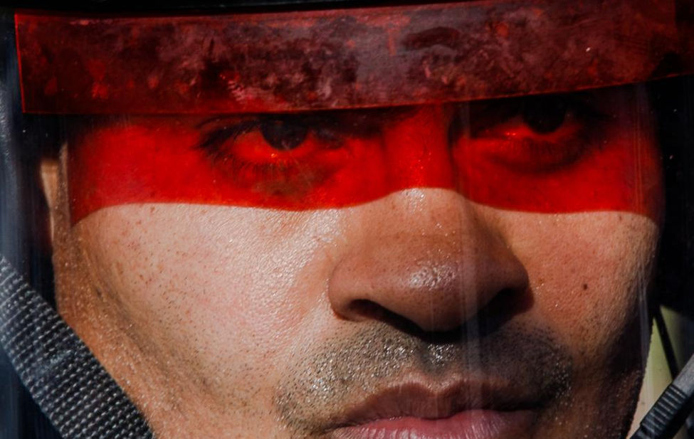 Portrait of a Boston police officer in riot gear.