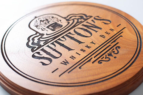 Mahogany solid hardwood with laser etched and engraved logo for a charred deep effect, with decorative routed edge.