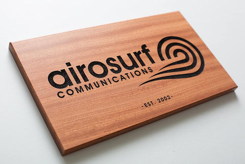 Solid natural mahogany hardwood engraved logo with deep laser charred recessed company logo.