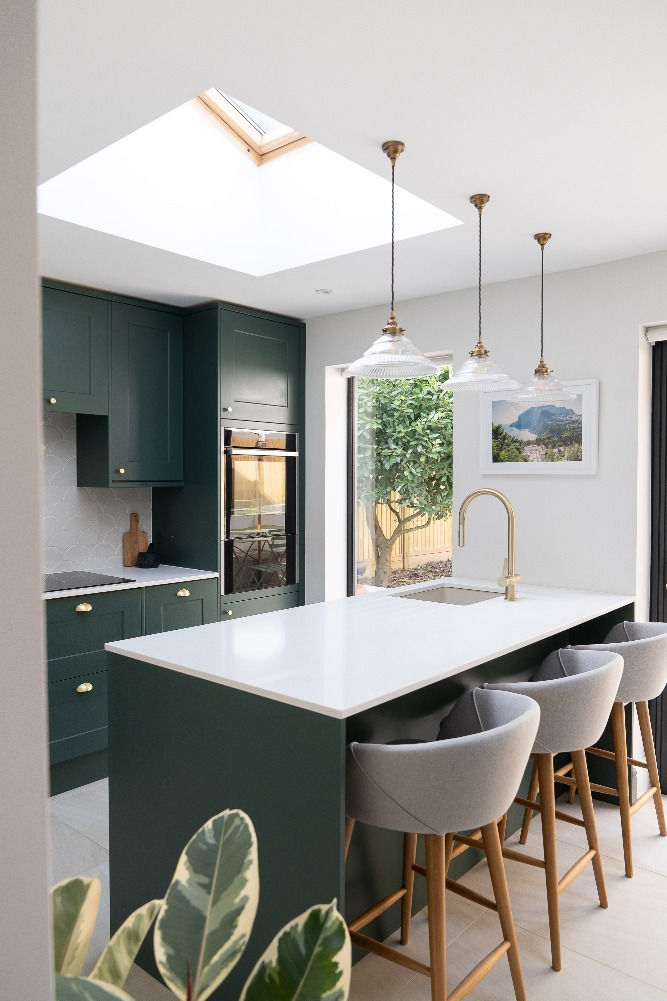 Designer kitchen with green cabinets and skylight