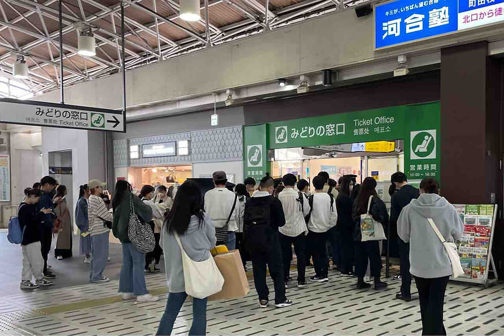A long line of locals at Machida Station in western Tokyo waiting in line for the 10AM drop.