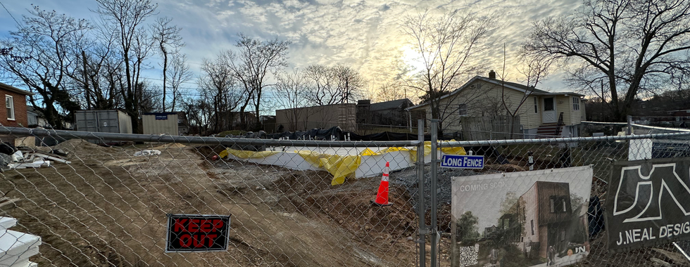 Photo of an open, fenced vacant lot in the Curtis Bay neighborhood, reserved for future construction.