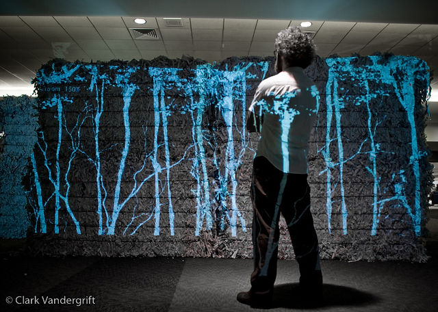 Projected trees on textured paper bales with steel wire bands