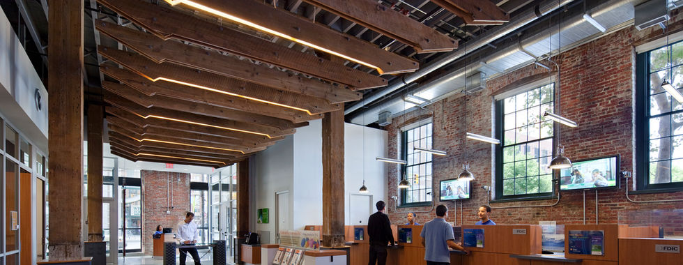 Bank teller area with custom linear wood light fixture 