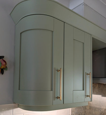 Curved handmade kitchen cabinetry refinished in Vert de Terre