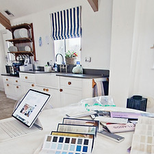 Kitchen design consultation with paint samples and colour palettes being considered in a family kitchen.