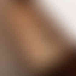 Bespoke kitchen in Cardiff featuring walnut-stained oak cabinetry with clear coat finish and Farrow & Ball Ammonite spray-finished units, handcrafted by Adam Farmer Bespoke Fitted Furniture and professionally sprayed by Bespoke Spray Cardiff, showcasing luxury custom joinery, modern design, seamless cabinetry lines, premium finishes and contemporary kitchen styling in South Wales