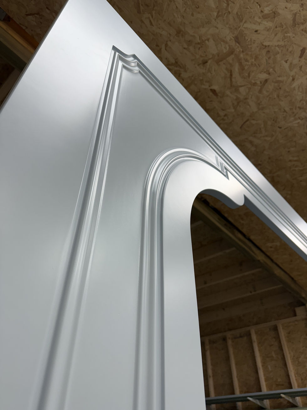 Detail shot of curved panel, freshly resprayed in white satin for a smooth, modern finish.