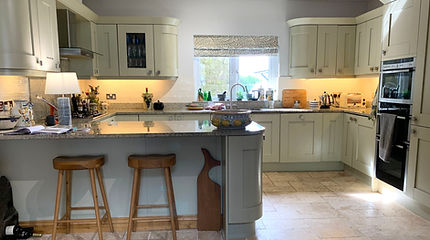 Before photo showing original cabinetry, lighting and square handles