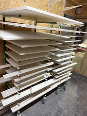 Racks loaded with doors after refinishing 