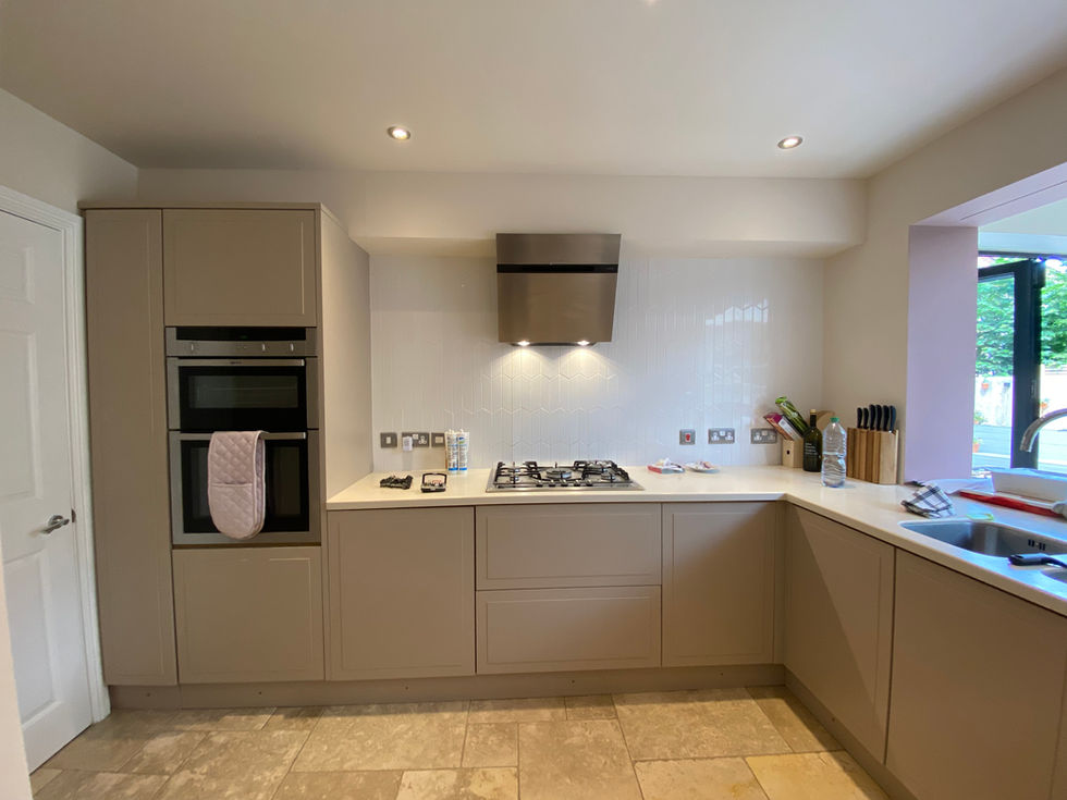 After respray: same kitchen in sulking room paint, with upgraded modern satin finish and clean white tile backdrop.
