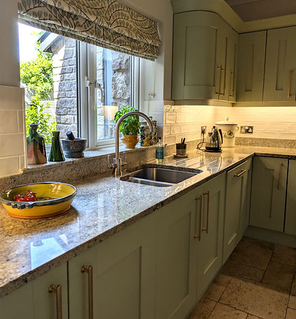 Vert de Terre kitchen cabinetry with brass handles and stone worktops