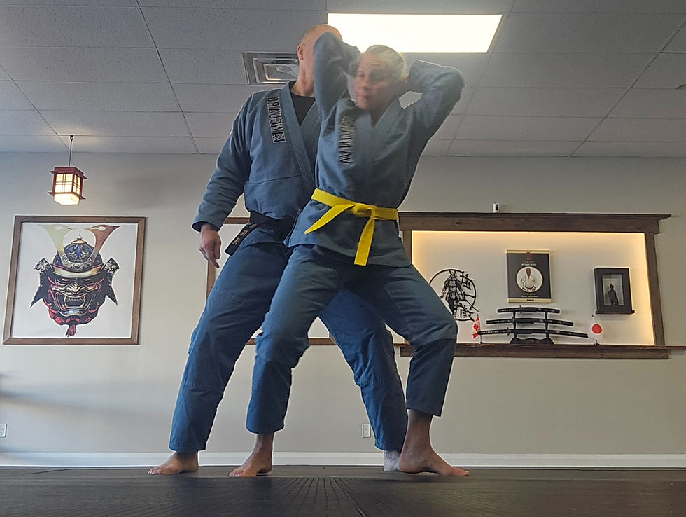 Woman in yellow belt practicing women self-defense technique