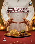 Person in thobe with samosas and falafel. Text: "YOU SHOULD BE AT THE TABLE FIRST"