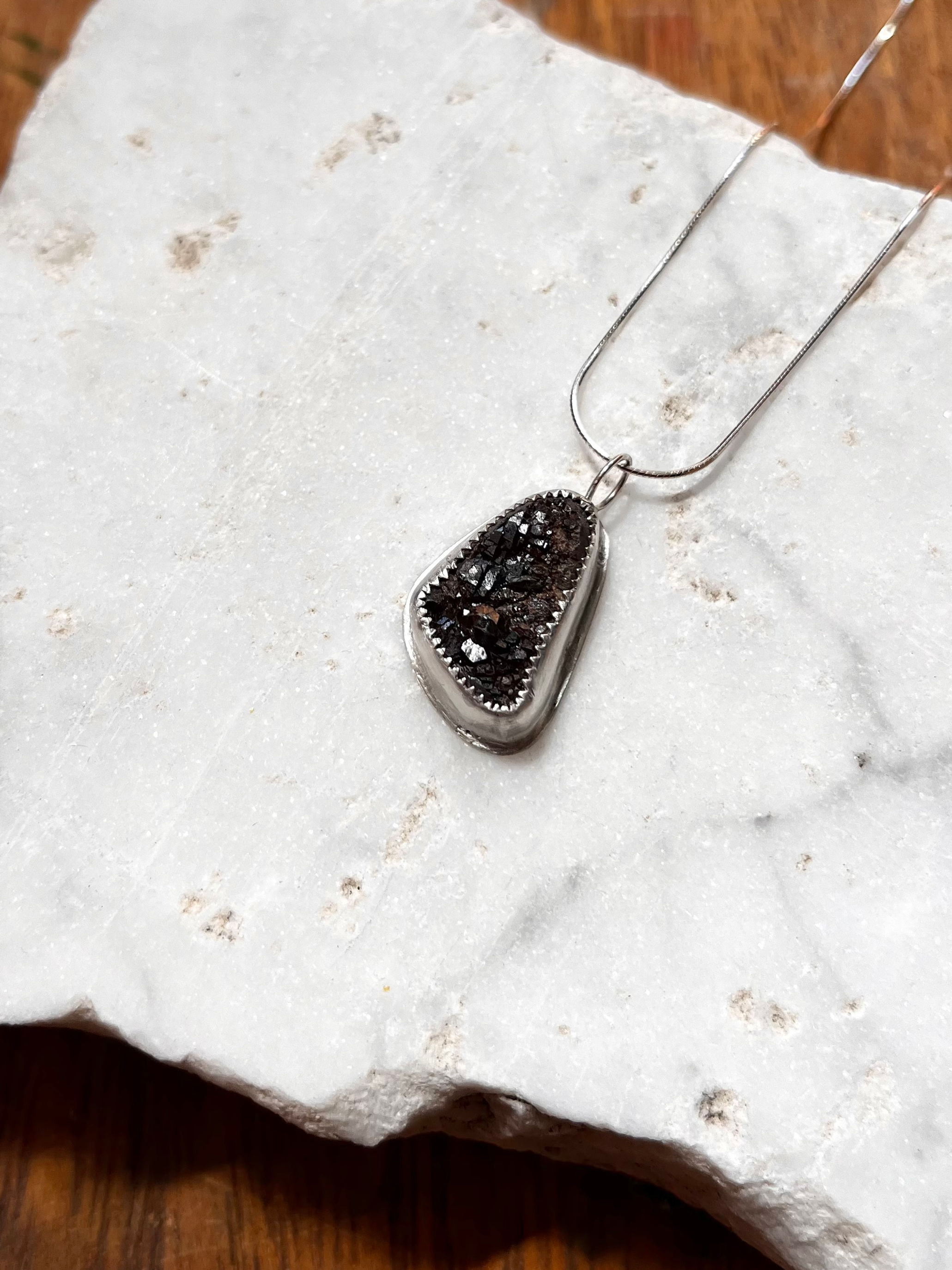 raw garnet stone from colorado made into a pendant by Julia Simpson