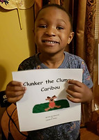 Children with their copies of "Clunker the Clumsy Caribou" book.