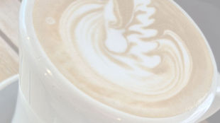 Mum enjoying quiet morning coffee after learning how to stop baby waking early