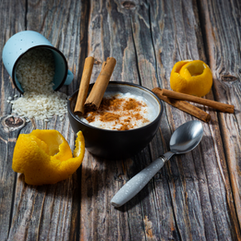 A bowl of fresh fruits and cereal topped with a sprinkle of Ceylon cinnamon for added flavor and wellness.