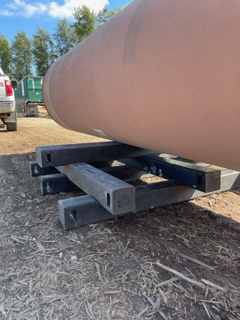 Close-up of a Skid Tech skid with built-in handles, highlighting the lightweight design and easy maneuverability for pipeline construction.
