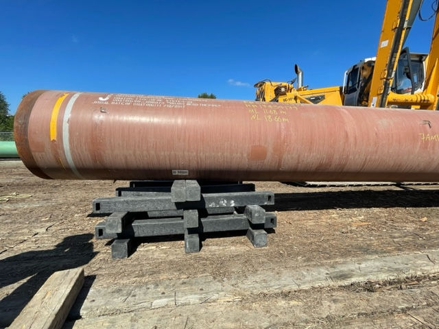 Skid Tech skid pile in use, demonstrating the secure interlocking system and pipe saddle design for safe pipeline support.