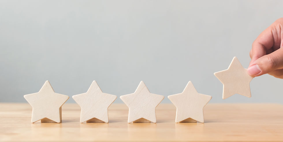 Hand putting wooden five star shape on table. The best excellent business services rating