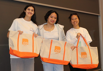 Three girls proudly showing their merchandise.