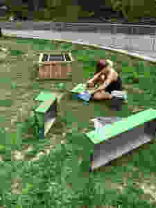 using an orbital sander to remove green paint frmo a buffet to repaint