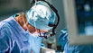 A surgeon performing a urinary diversion with cystectomy to treat complications of genitourinary syndrome of menopause