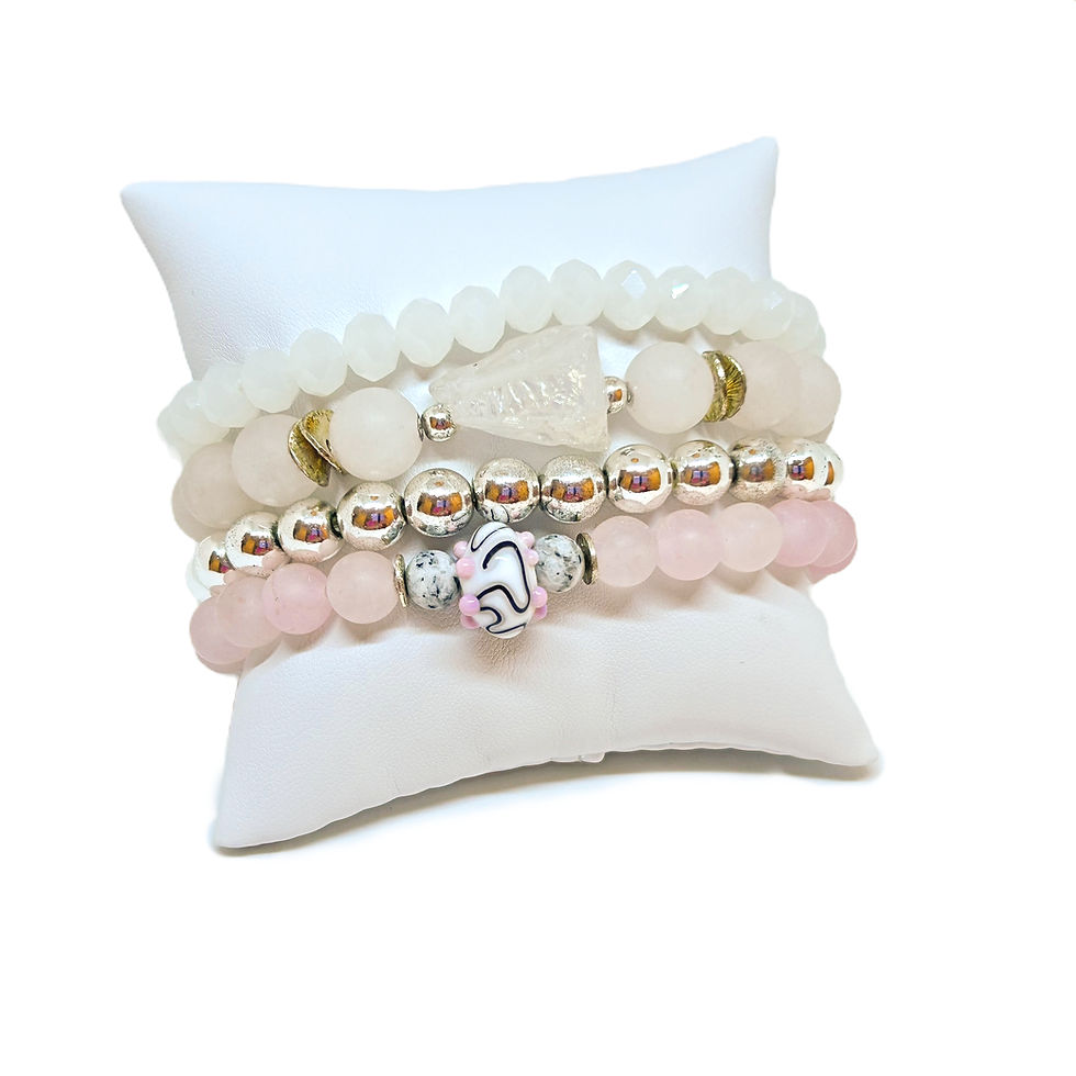 Thumbnail: gemstone bracelets on a white pillow