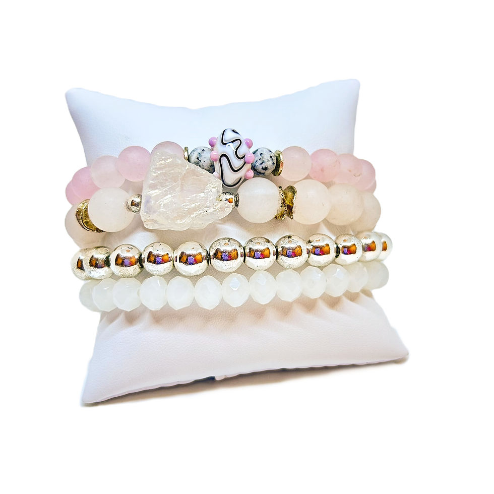 Jade and Quartz healing bracelets on a white pillow