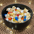 Bowl of popcorn with marshmallows and M&Ms on top