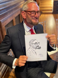 Wedding guest having their caricature drawn during the wedding breakfast at Dulwich College