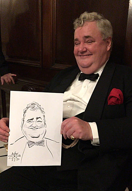 A man holds up his caricature