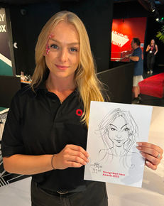 Events team member holding up her caricature at the Paradox Museum in Knightsbridge