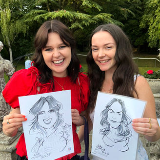 Birthday party guests holding up their caricatures