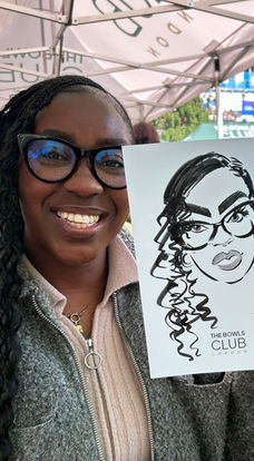 Young woman holding up her caricature at a company team-building event in the City of London