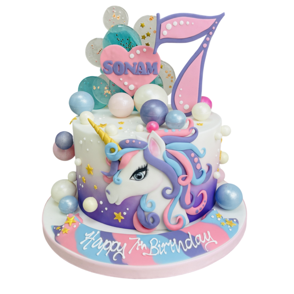 A stunning unicorn-themed cake with rainbow-coloured decorations and edible gold accents, perfect for a magical celebration.