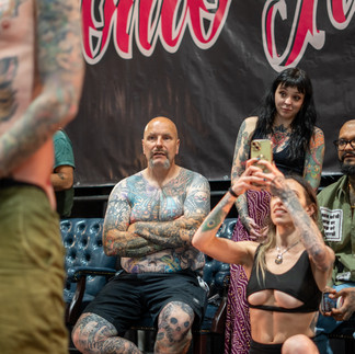 judging and taking pictures of tattoos competing for annual contests and showcases