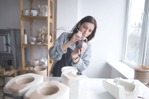 Woman Painting Pottery