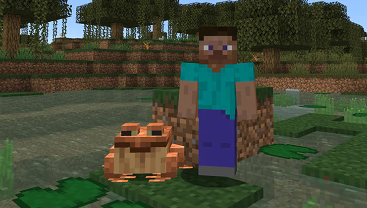 A green Minecraft frog sitting peacefully by a pond surrounded by lilypads and flowers.