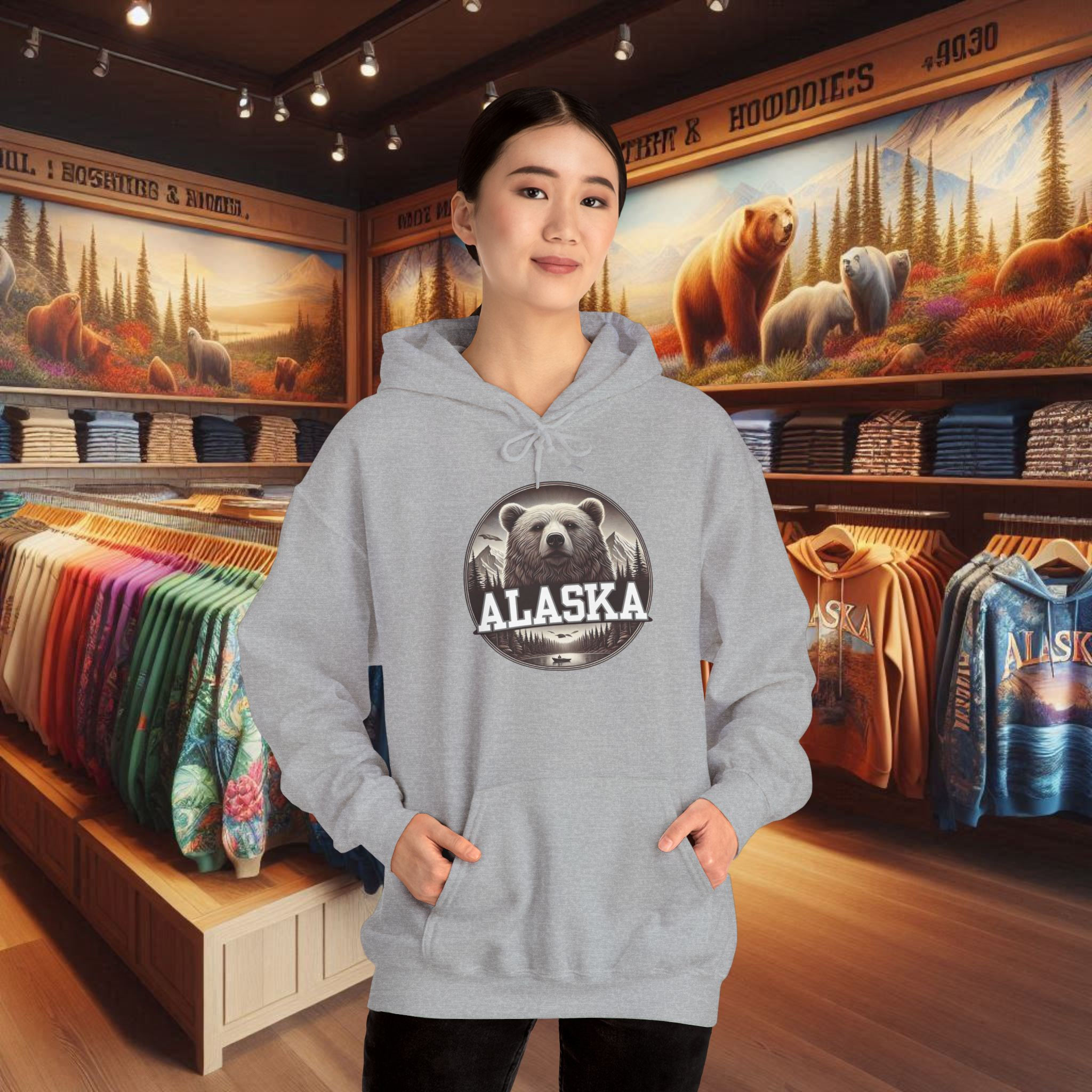Woman wears gray Women's Alaska comfort hoodie with bear