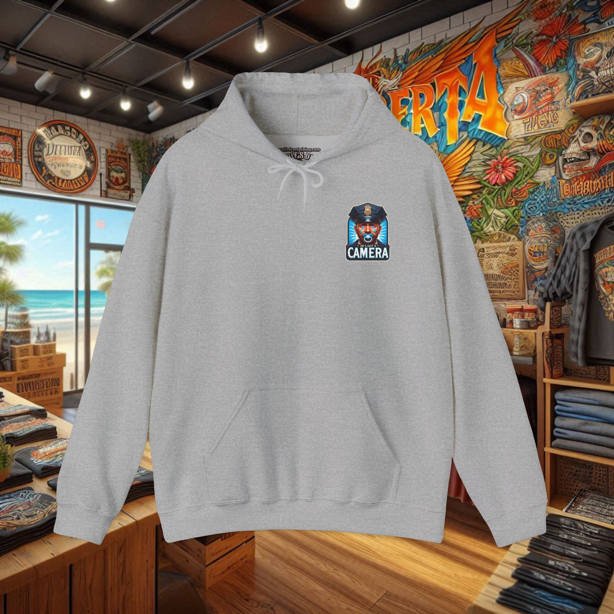 Light grey men's pullover hoodie with 'He's Got a Camera' emblem