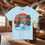 Thumbnail: Light blue t-shirt with "Alaska the Last Frontier" graphic. Wolf's Den Clothing